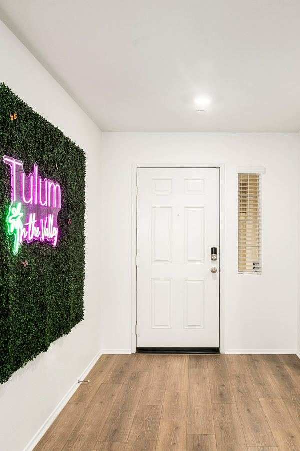 Entryway foyer with neon brand sign — Tulum in the Valley