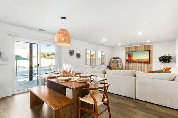 Open-concept living and dining room with sliding doors to pool deck