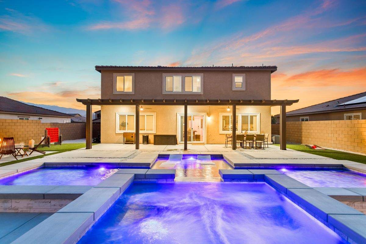 Private heated pool and spa lit up at night — Tulum in the Valley Coachella Valley luxury rental